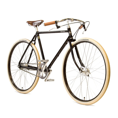 A classic black road racing bicycle with iconic North Road handlebars, cream tires, and a traditional Brooks B17 leather saddle.